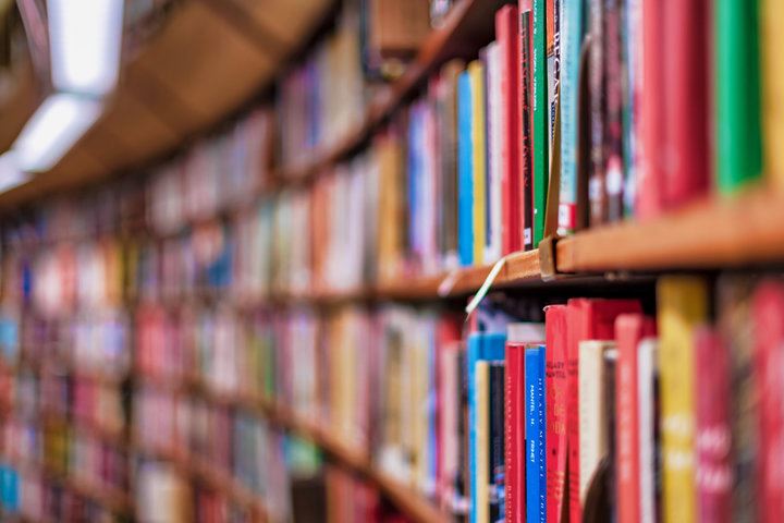 library shelves full of books curving to the left in the distance